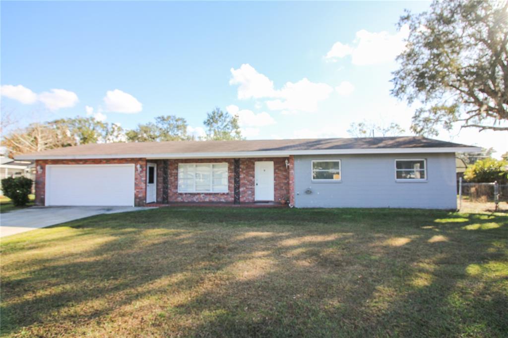 a view of a house with a yard and garage