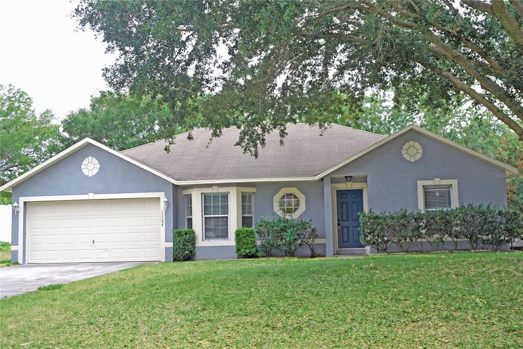 a front view of a house with a garden and yard