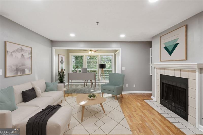 a living room with furniture large window and a fireplace