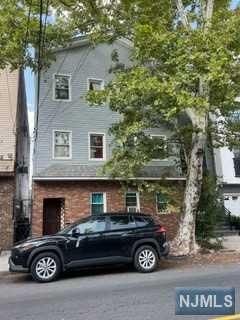 a view of a car parked front of a house