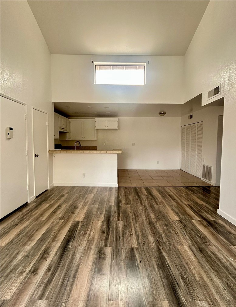 a view of a room with wooden floor