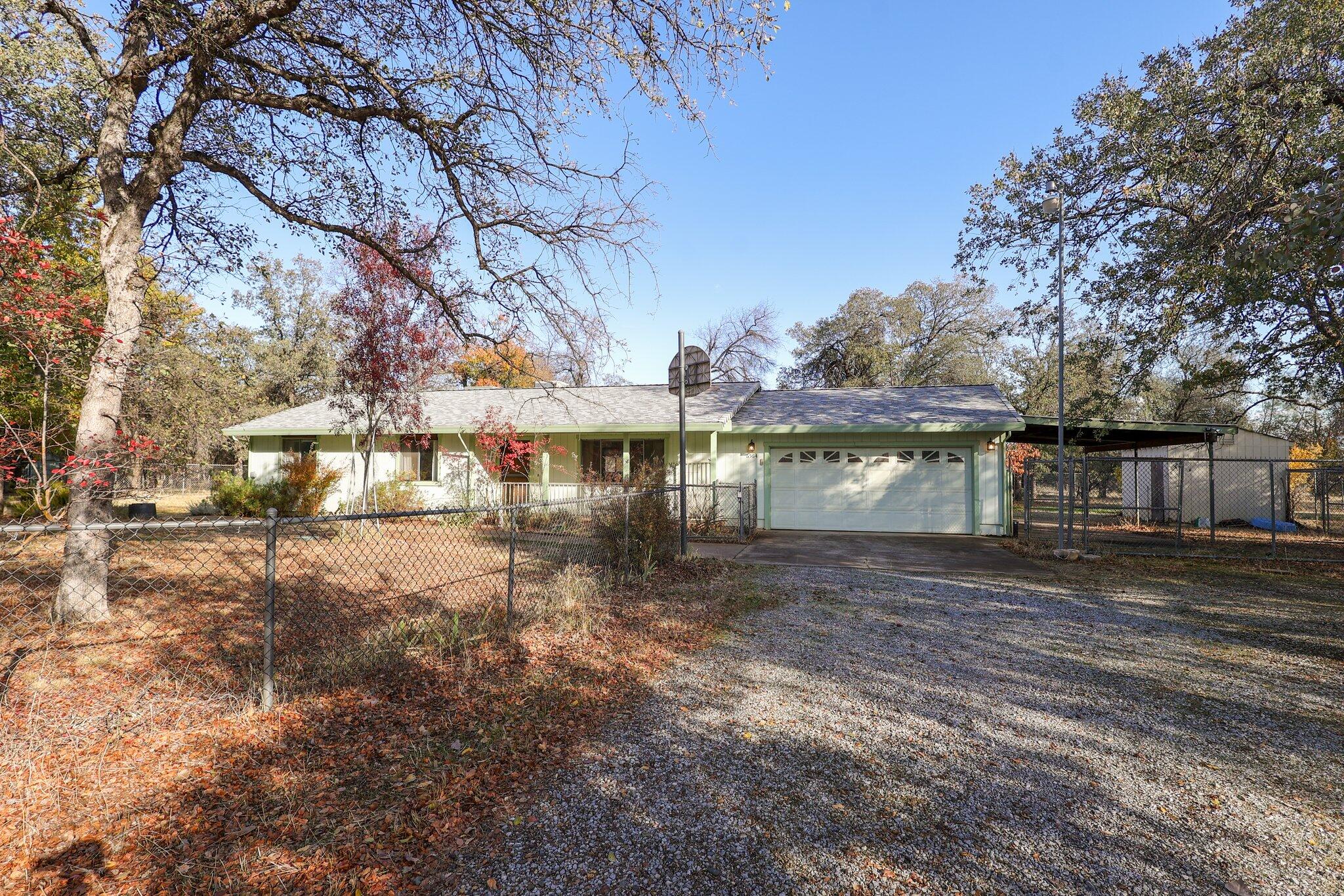 a front view of a house with a yard and lake view