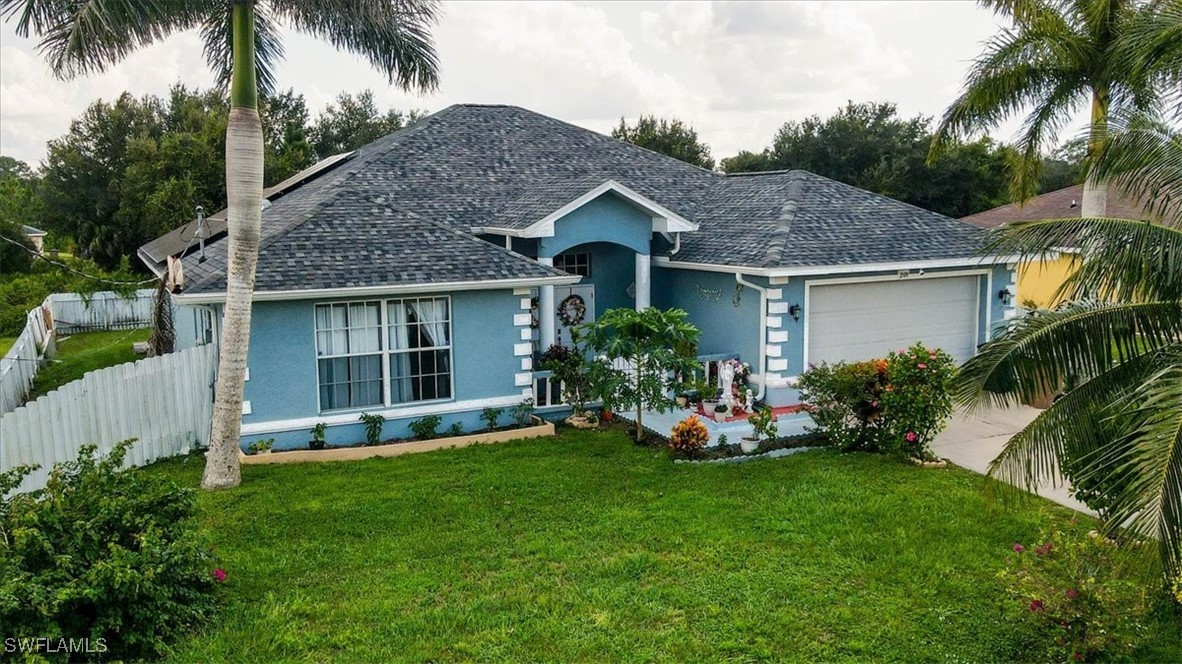 a front view of a house with a yard and potted plants