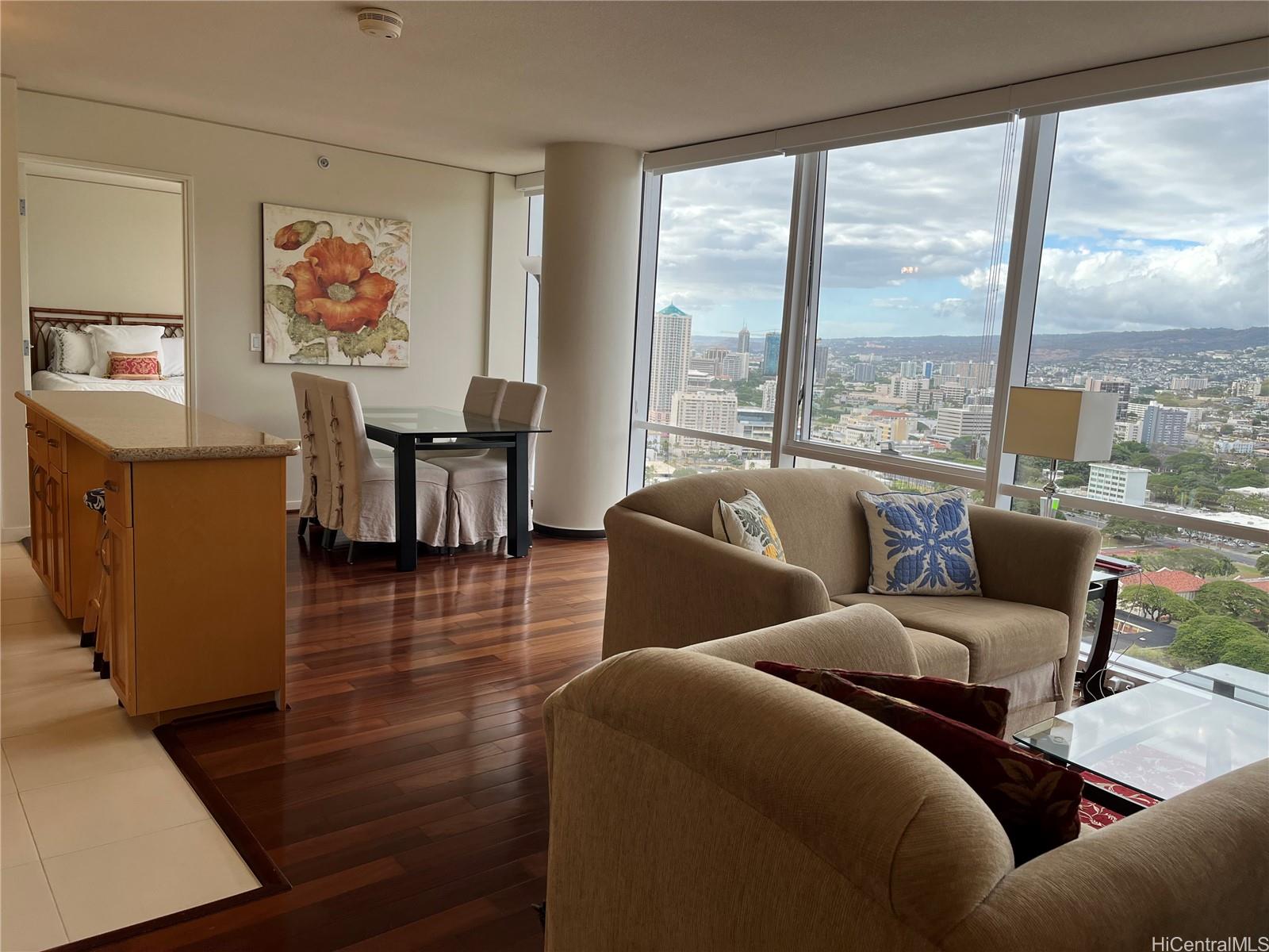 a living room with furniture water view and large windows