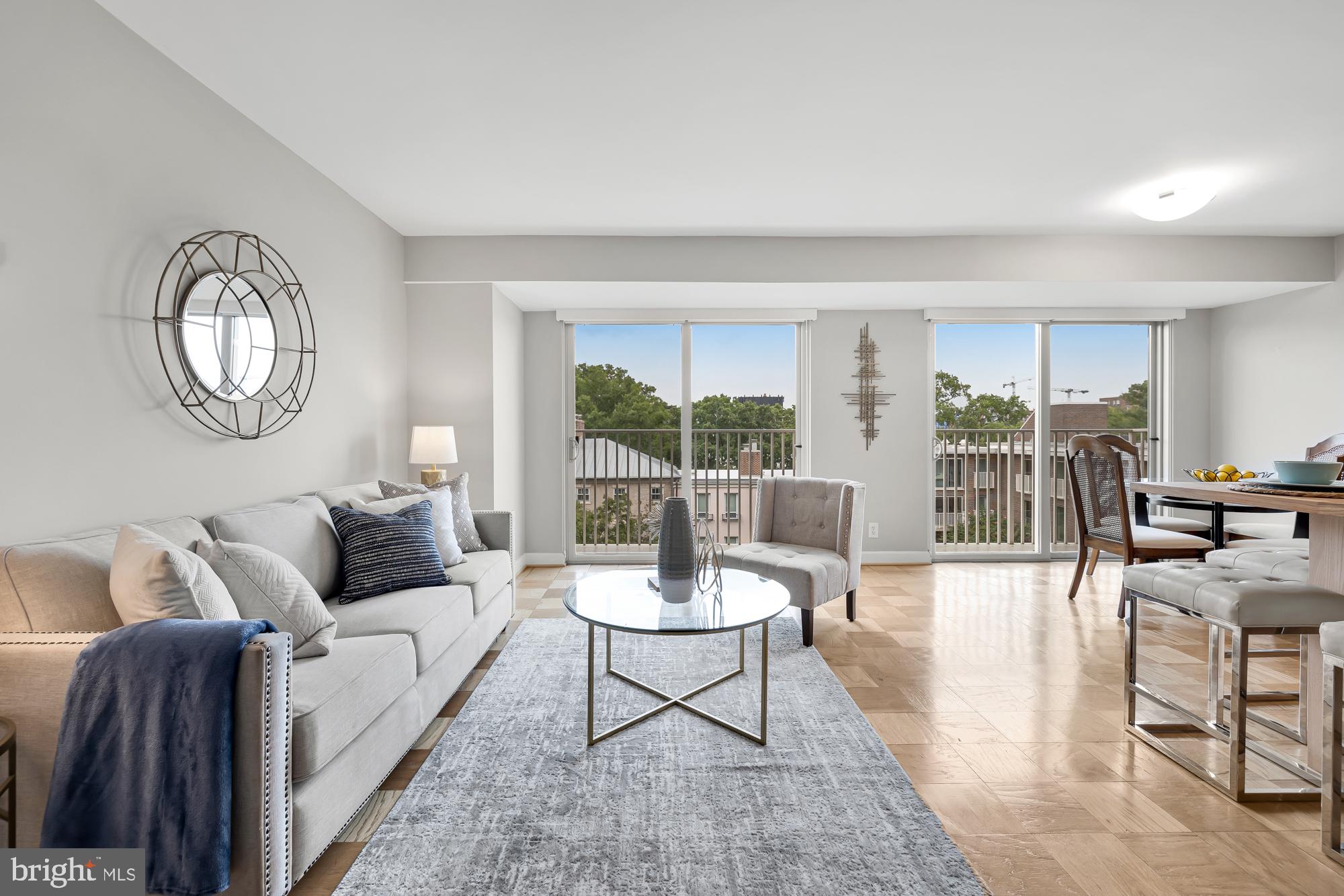 a living room with furniture a window and a table