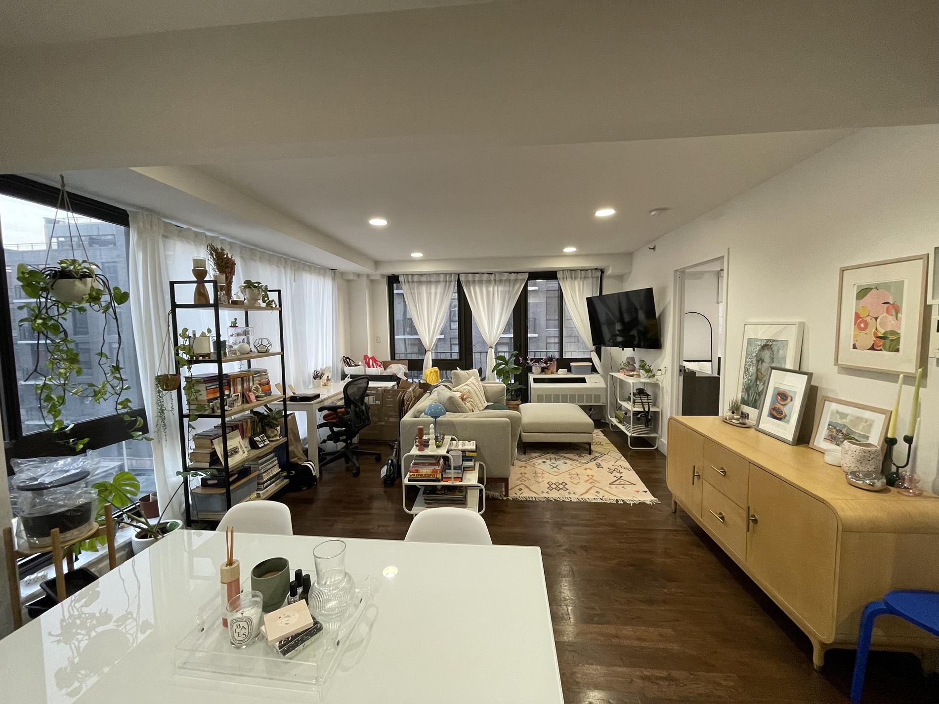 a living room with lots of furniture and a large window