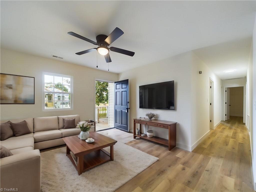 a living room with furniture and a flat screen tv