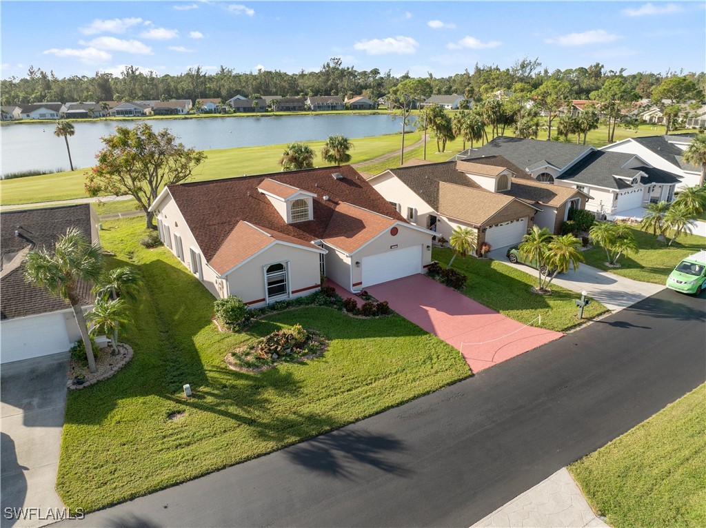 an aerial view of a house with outdoor space and lake view