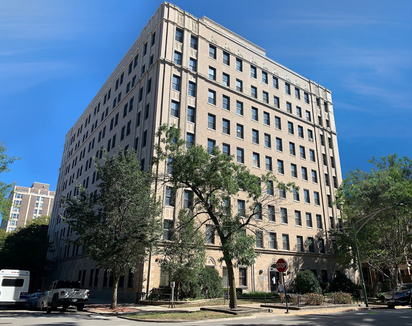 a view of a tall building next to a road