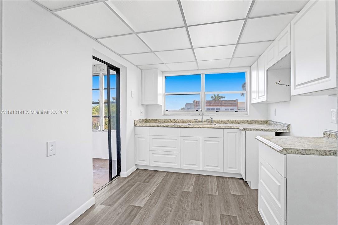 a kitchen with a sink a cabinets and window