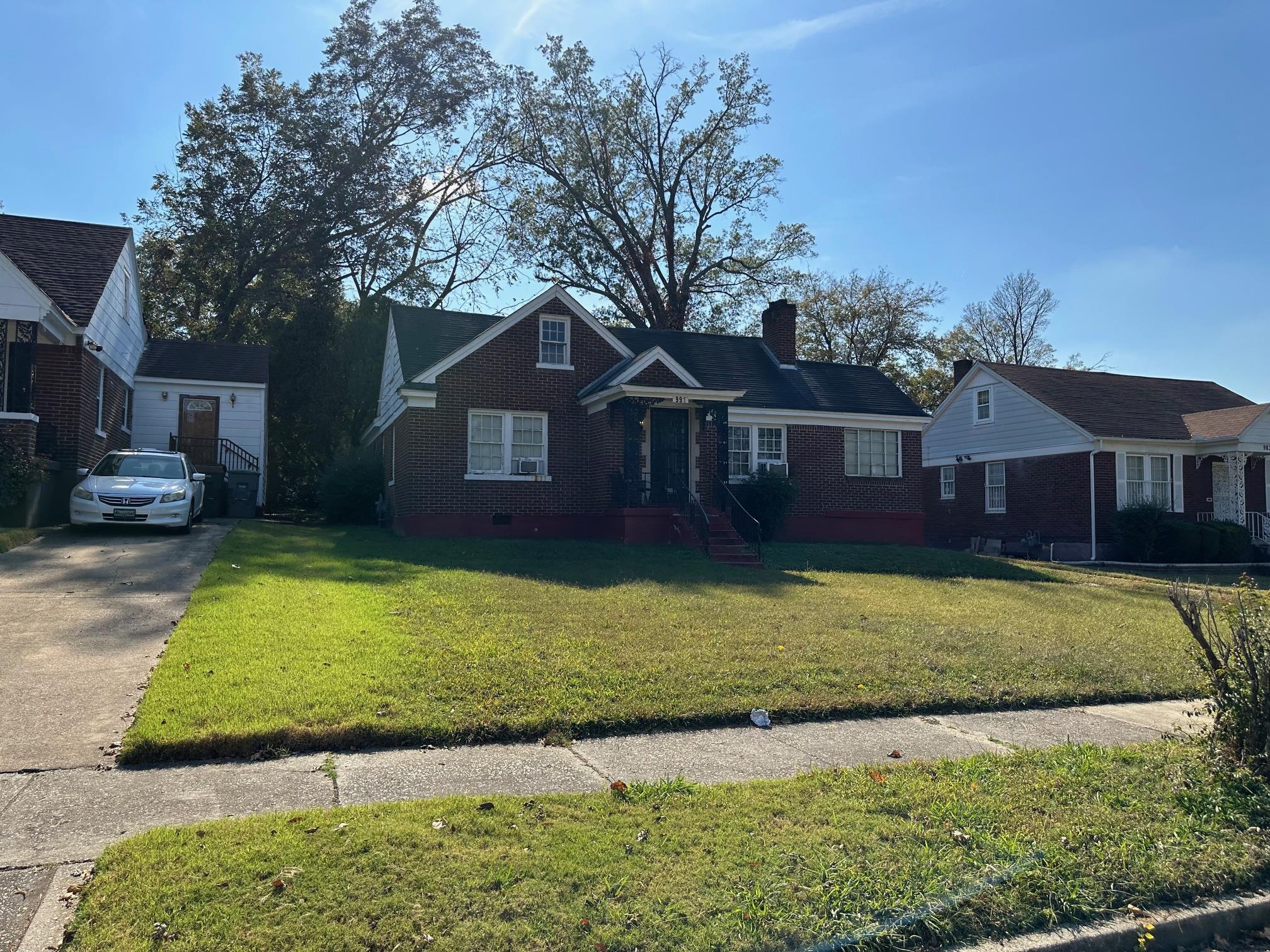 a front view of a house with a garden and yard