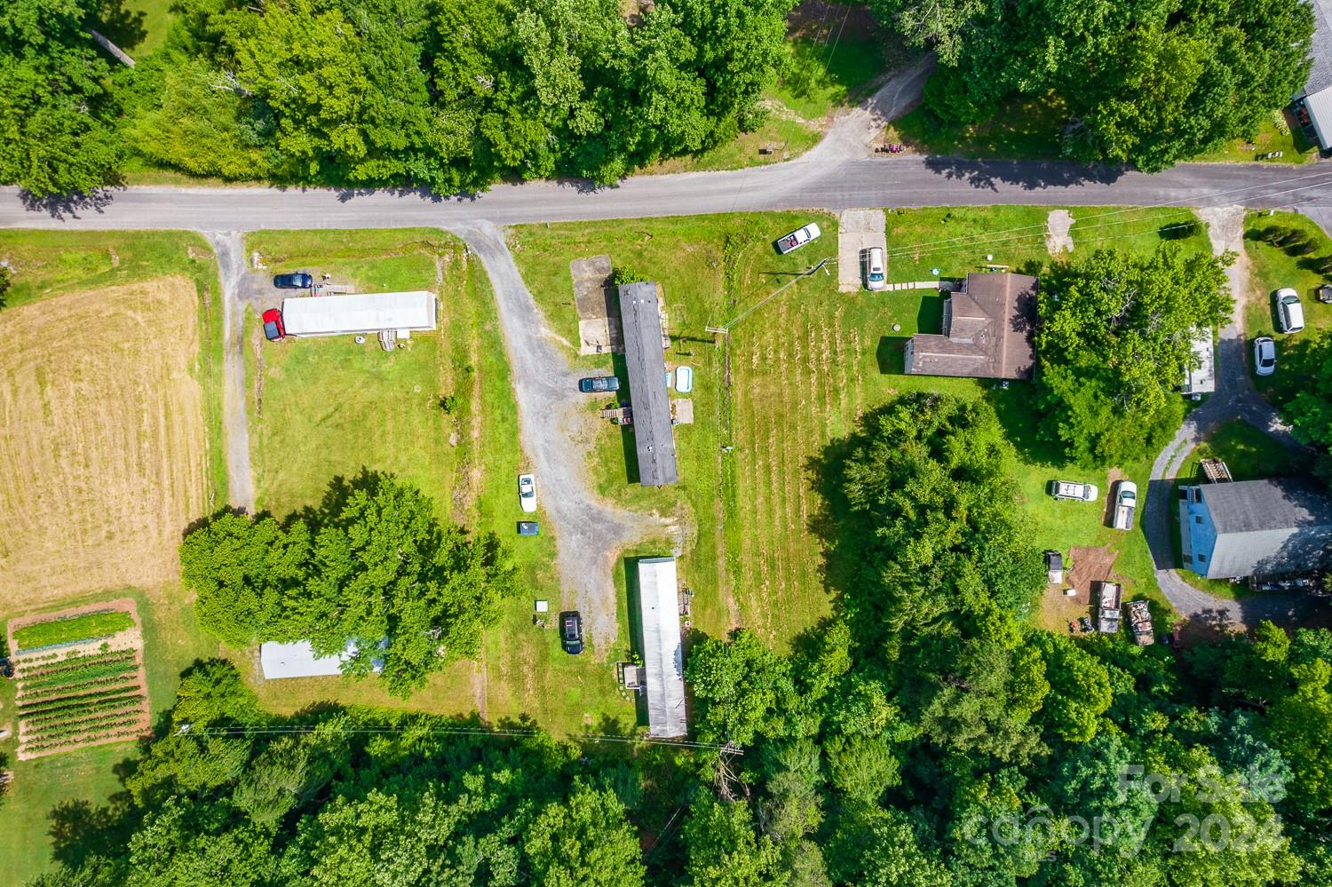 an aerial view of a swimming pool with a yard