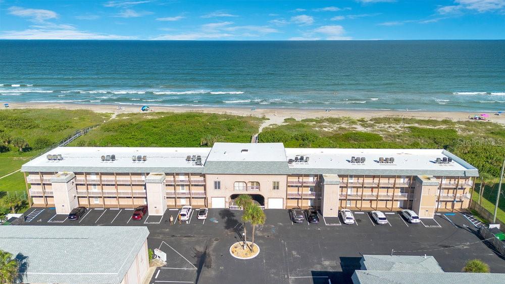 a view of an ocean with a building in the background