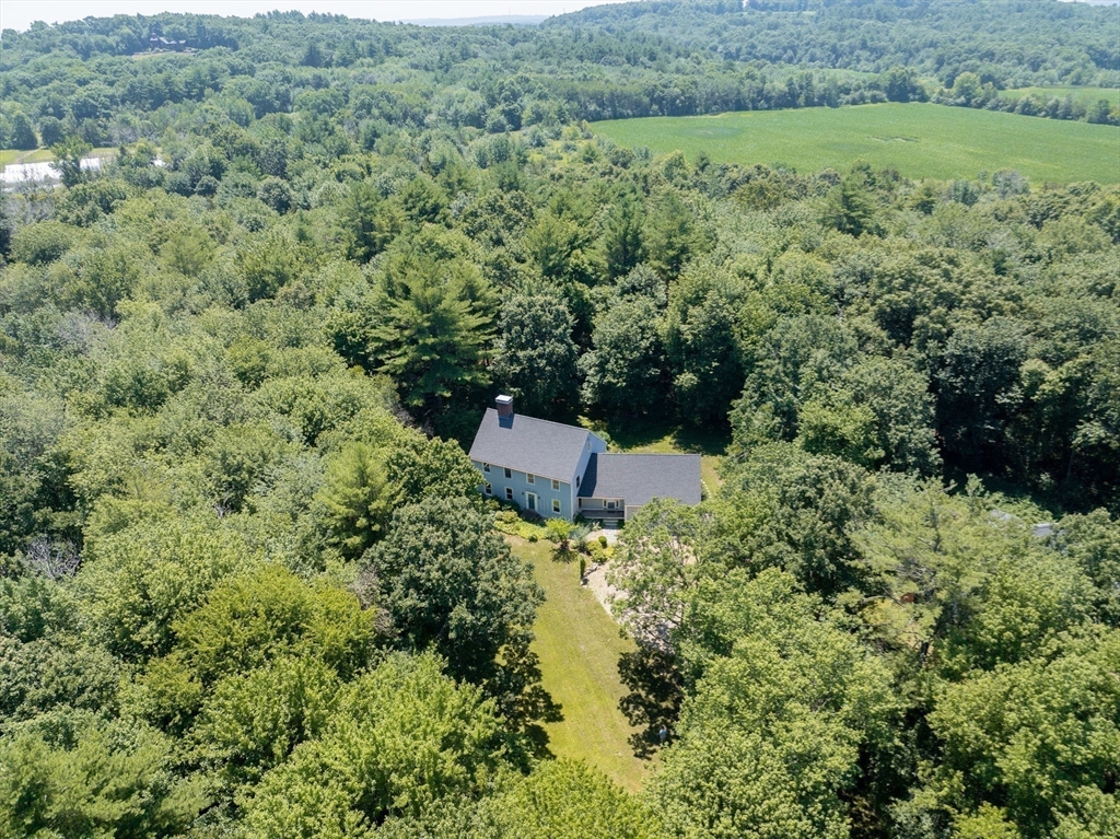 an aerial view of a house with a yard