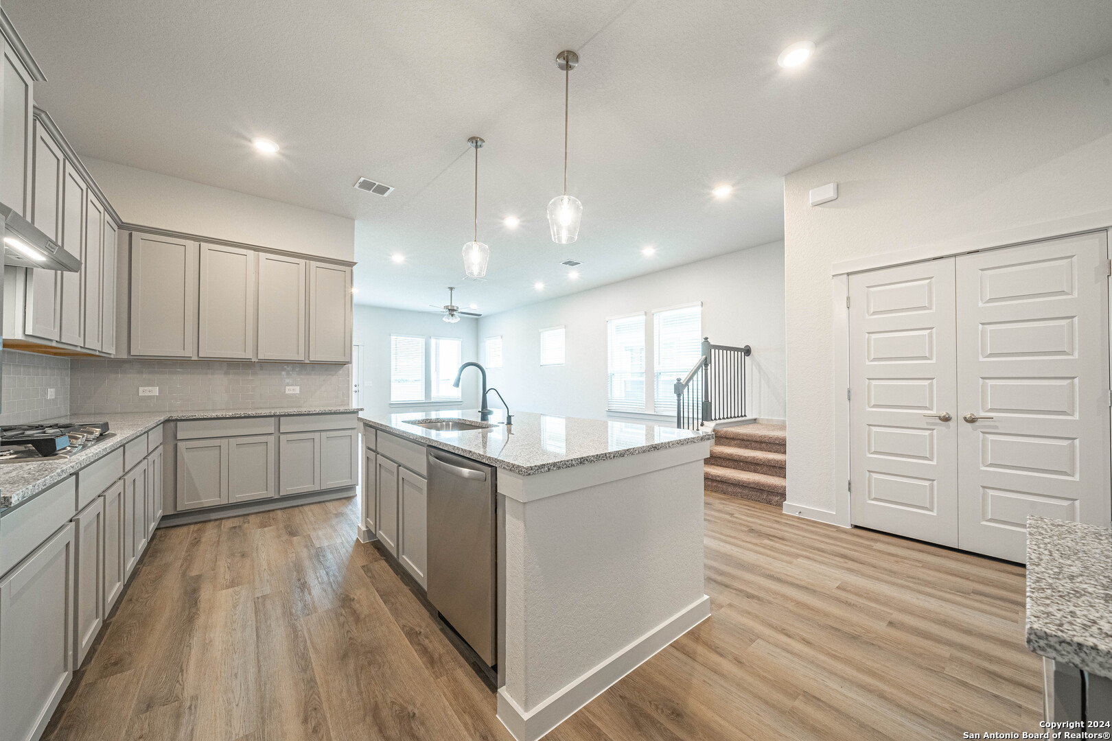 a kitchen with stainless steel appliances granite countertop a stove and a sink