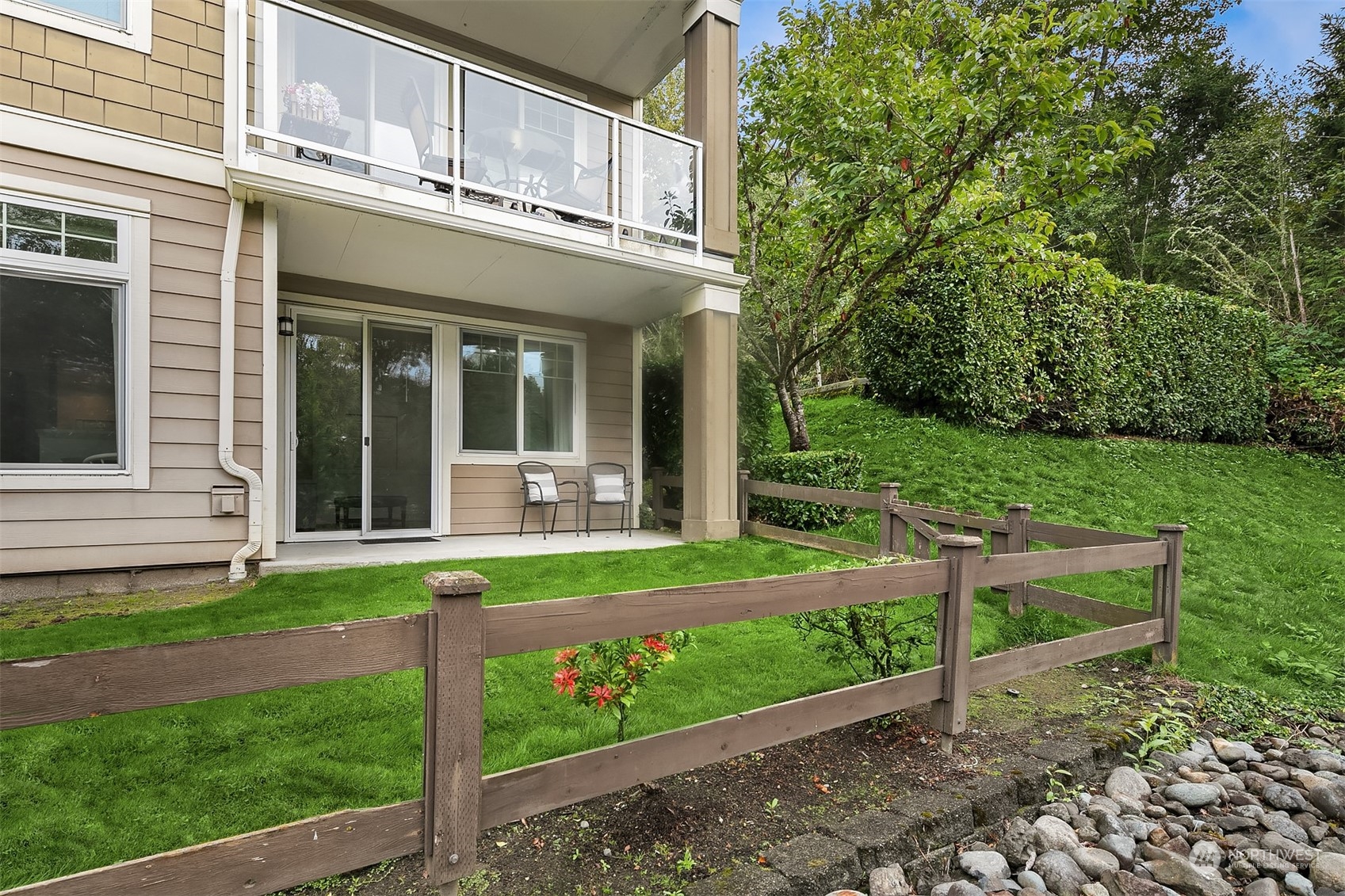 a view of a house with a yard and sitting area