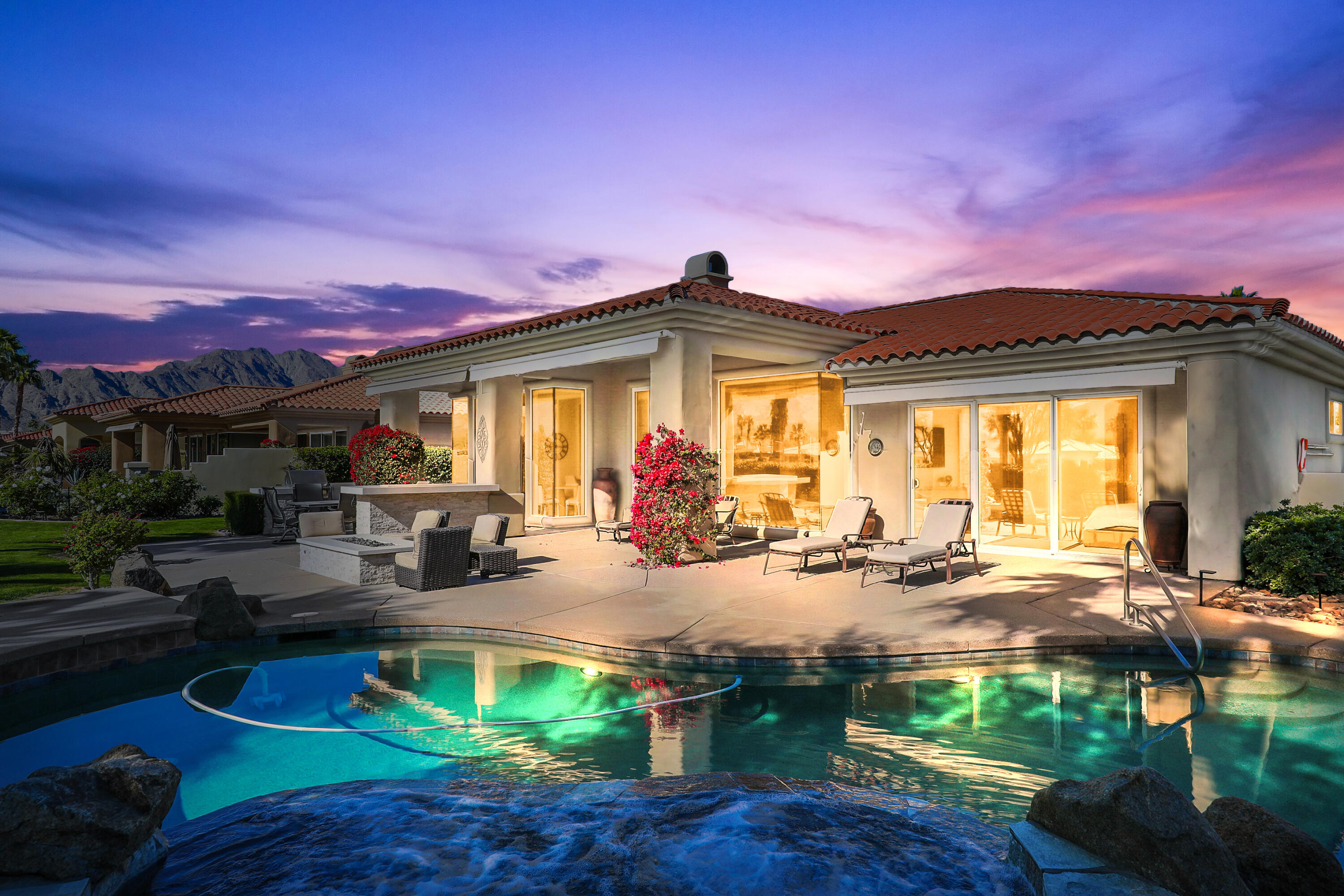 a front view of a house with swimming pool yard and outdoor seating