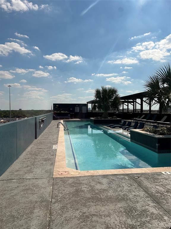 a view of a swimming pool with an outdoor seating