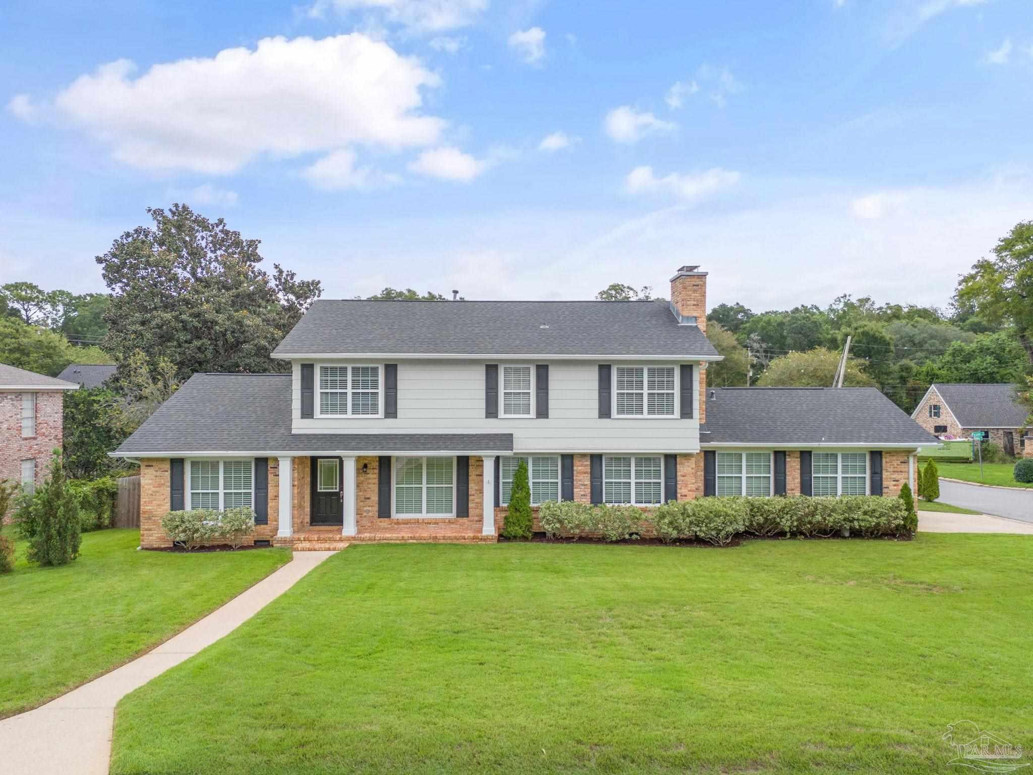 a front view of a house with a garden