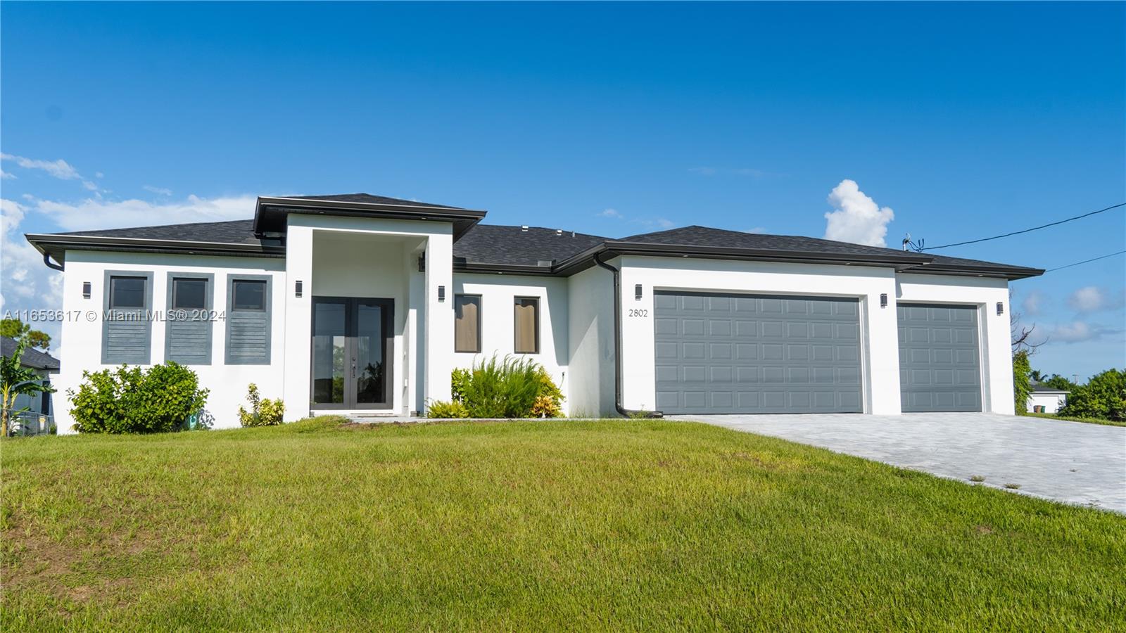 a front view of a house with a garden