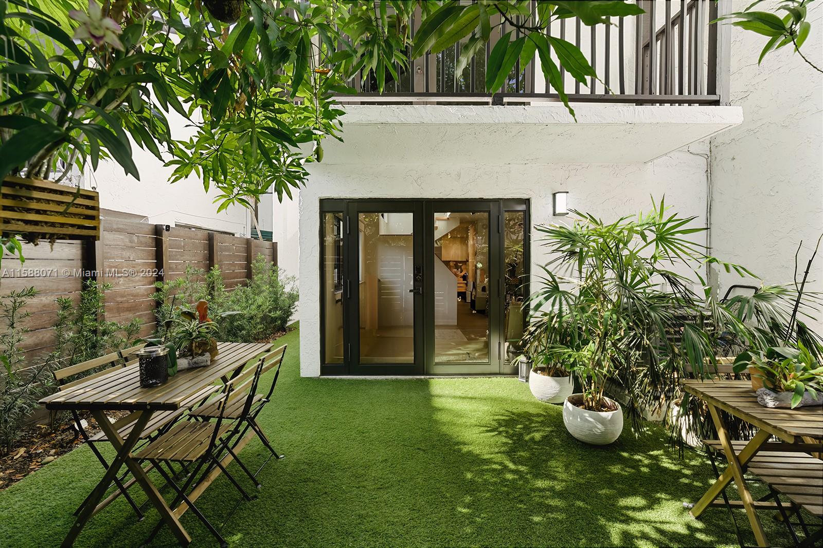 a view of an house with backyard and sitting area