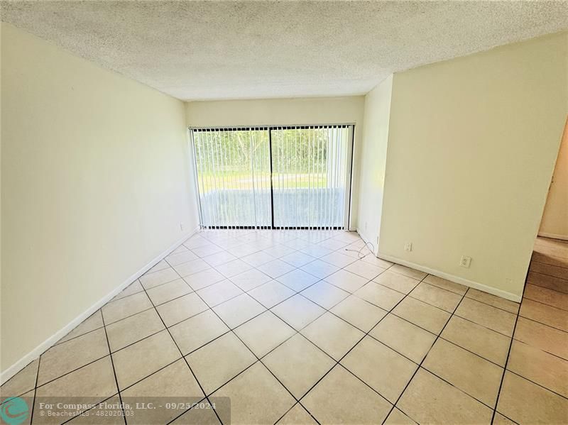 a view of an empty room and a window