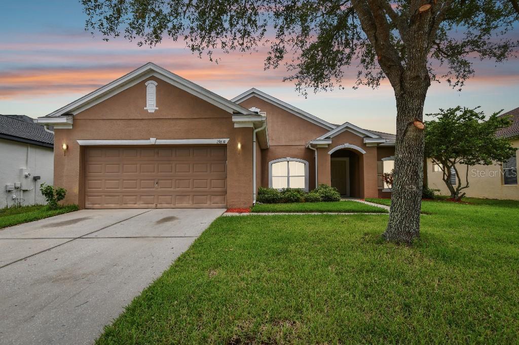 a front view of a house with a yard and garage