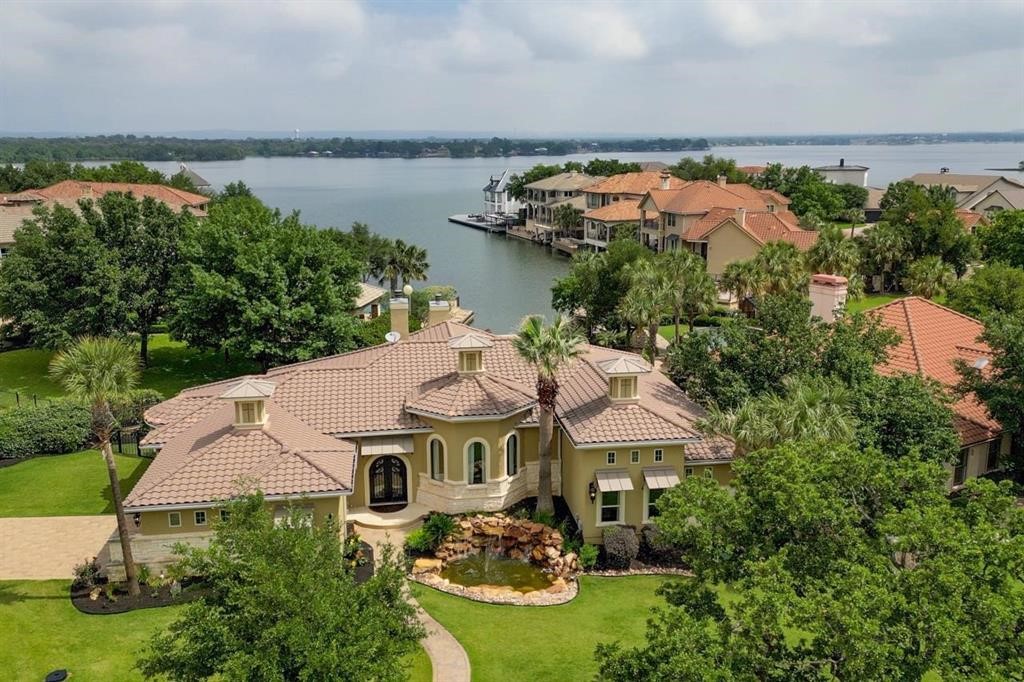 an aerial view of house with yard and lake view