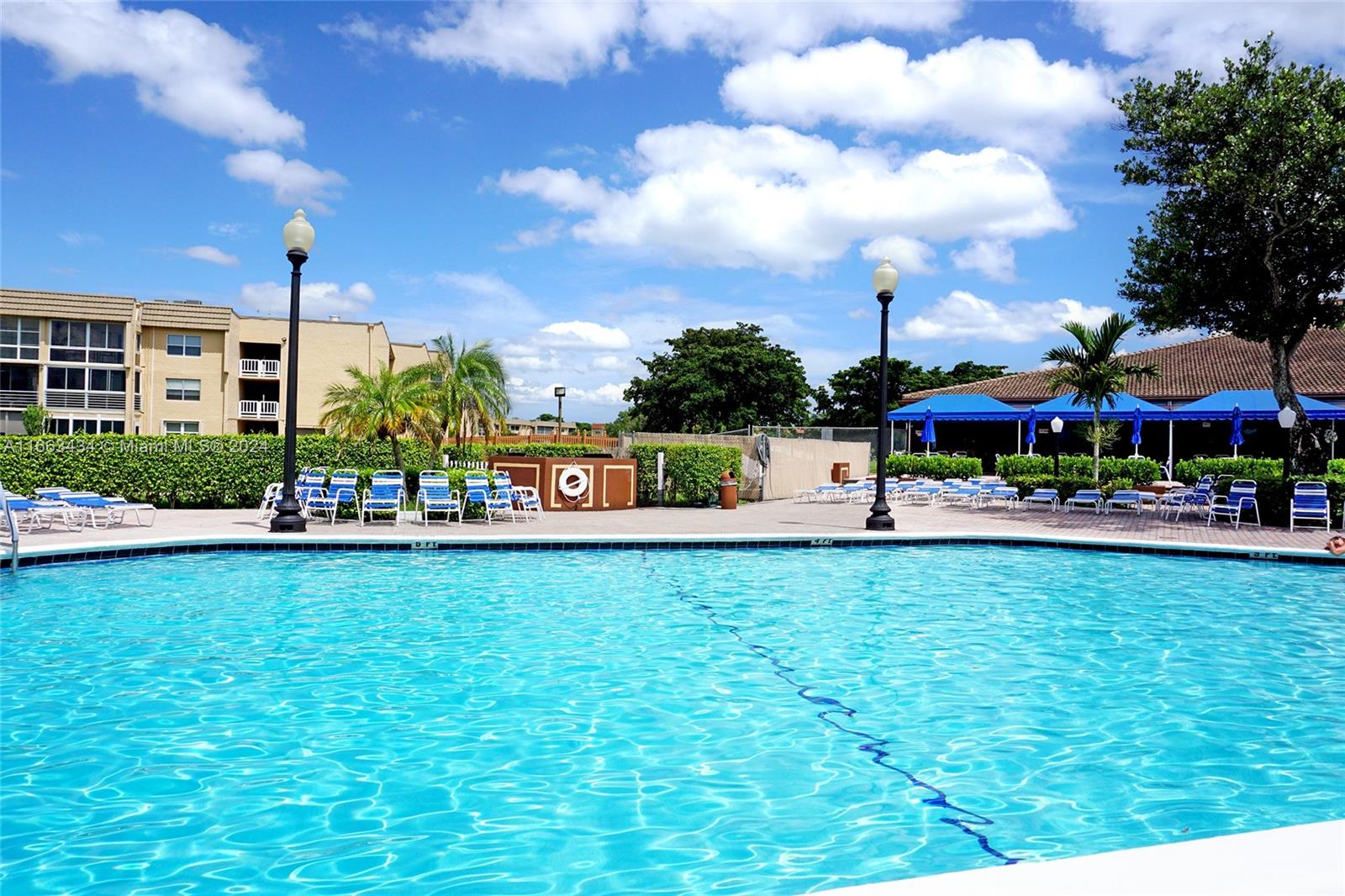 a swimming pool with outdoor seating and yard