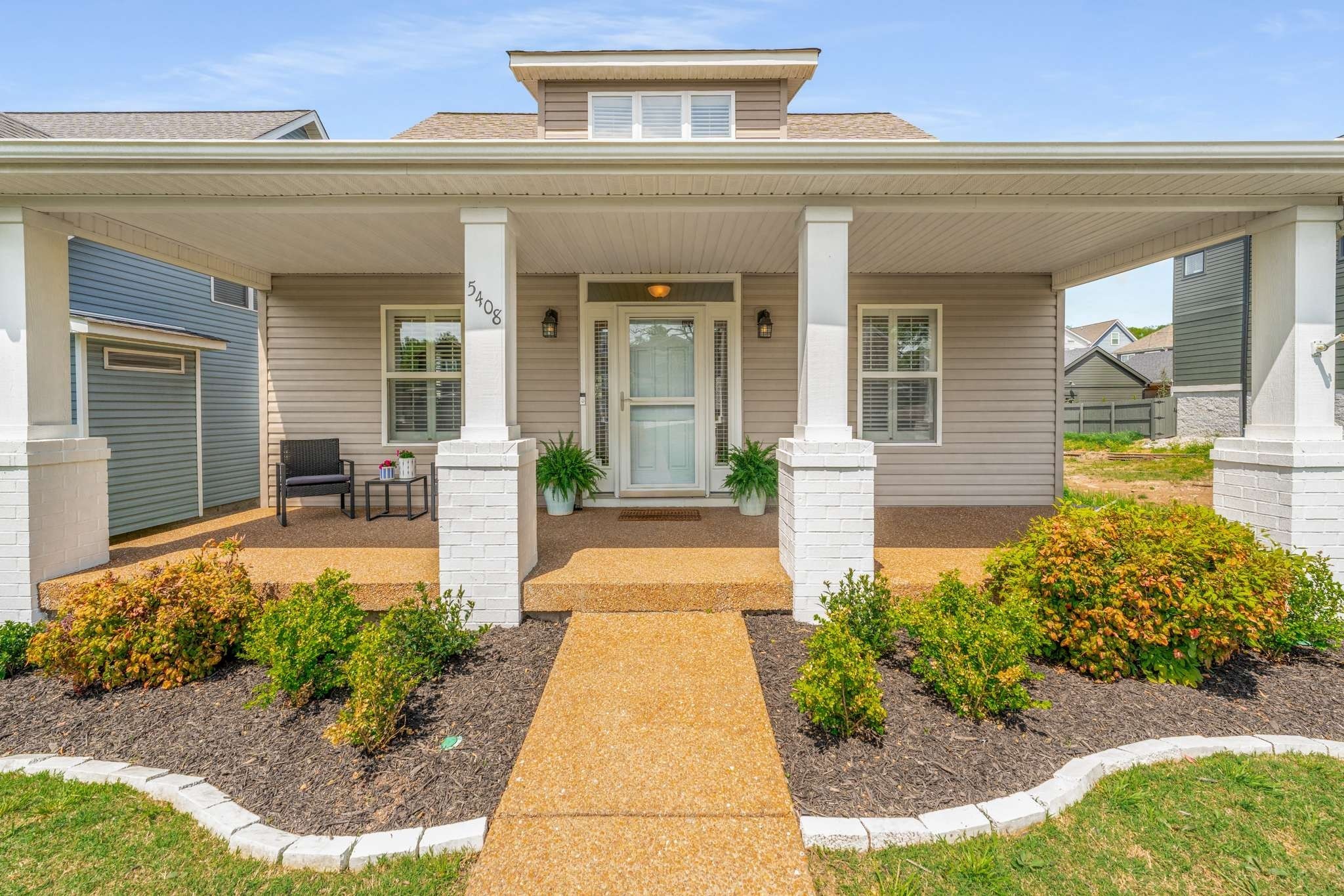 a front view of a house with garden