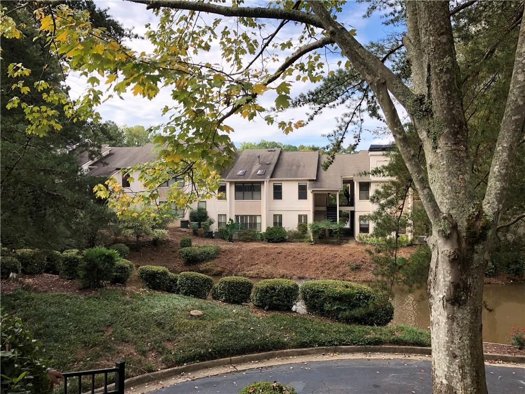 a view of house with a yard