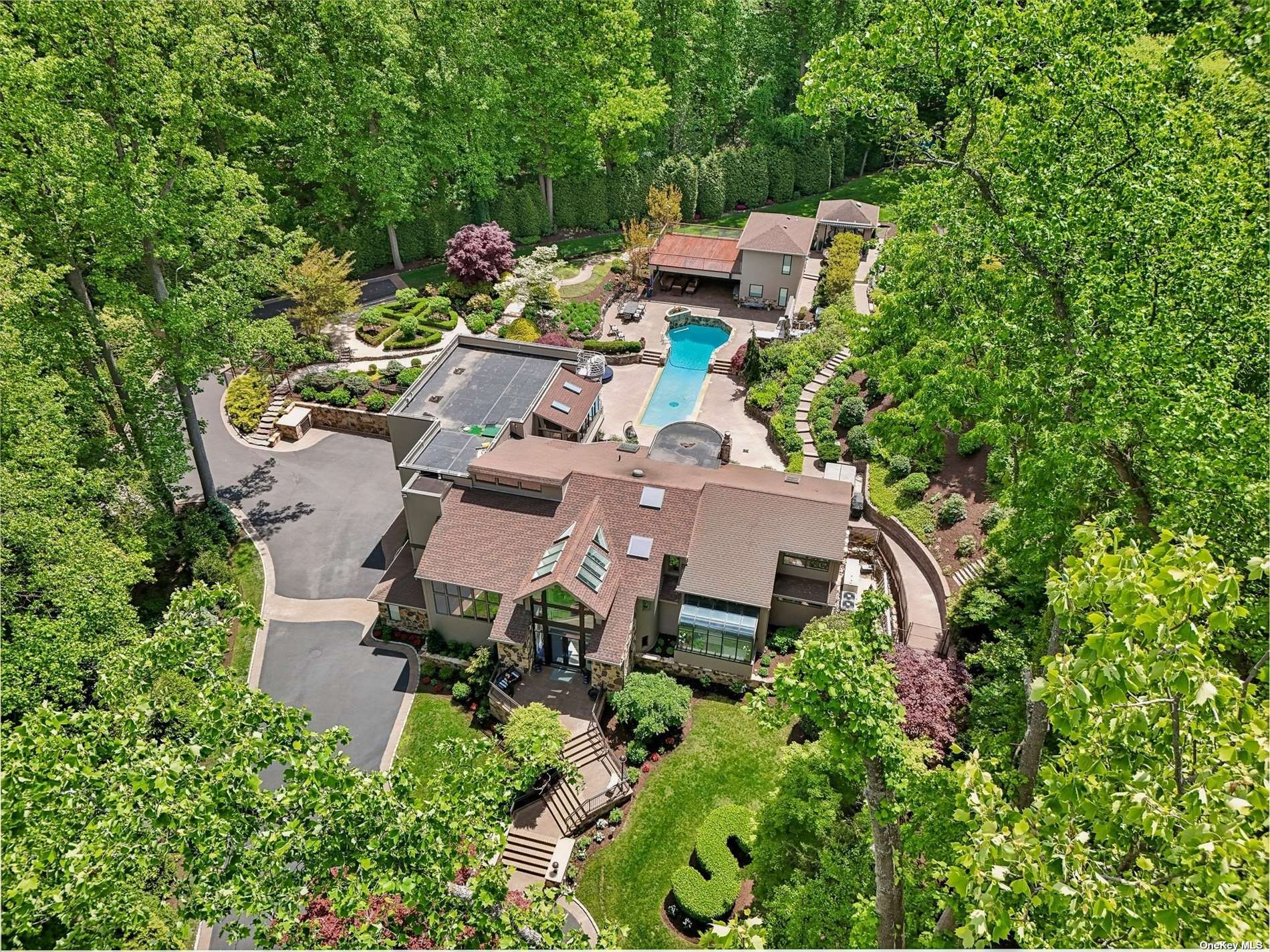 an aerial view of a house with a yard and lake view