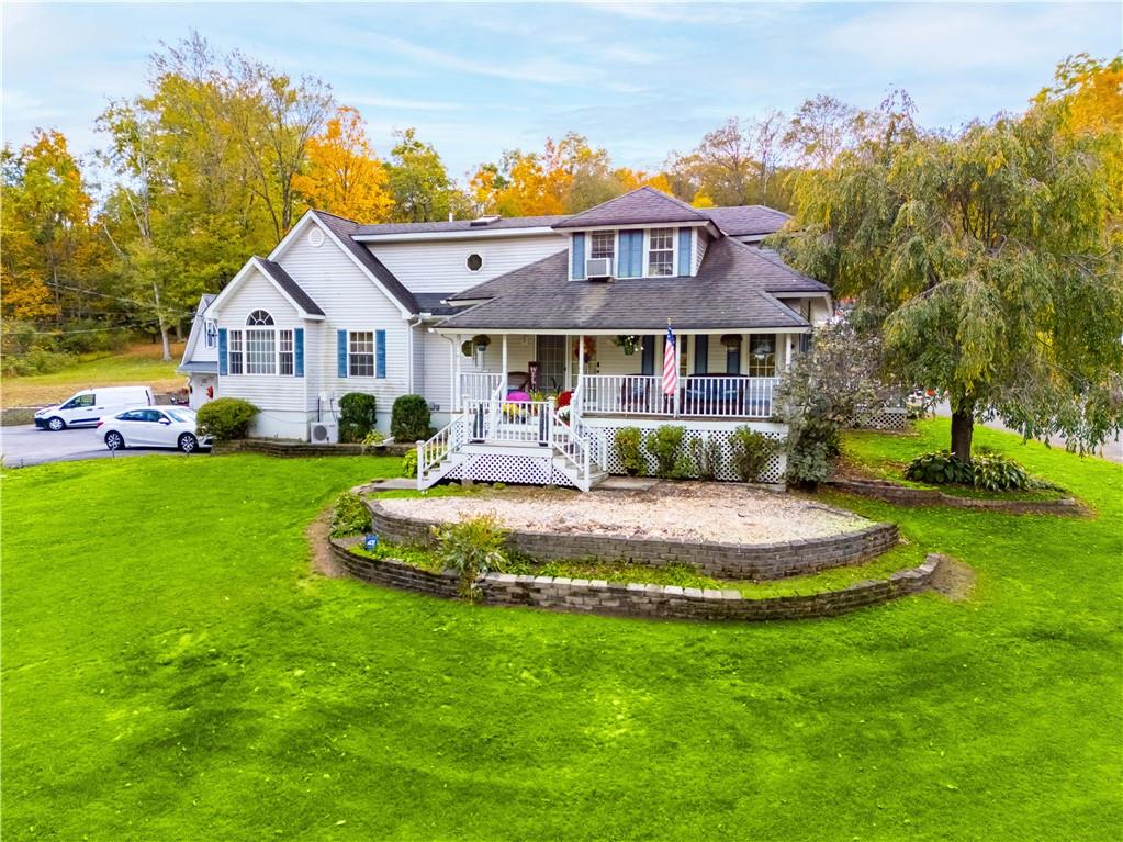 View of front of house featuring a porch and a front lawn