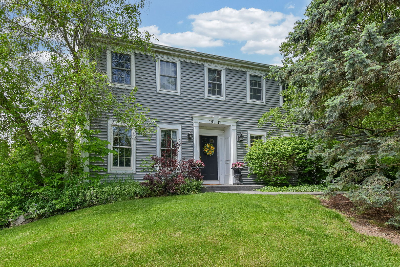 a front view of a house with garden