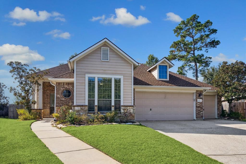 a front view of a house with a garden and yard