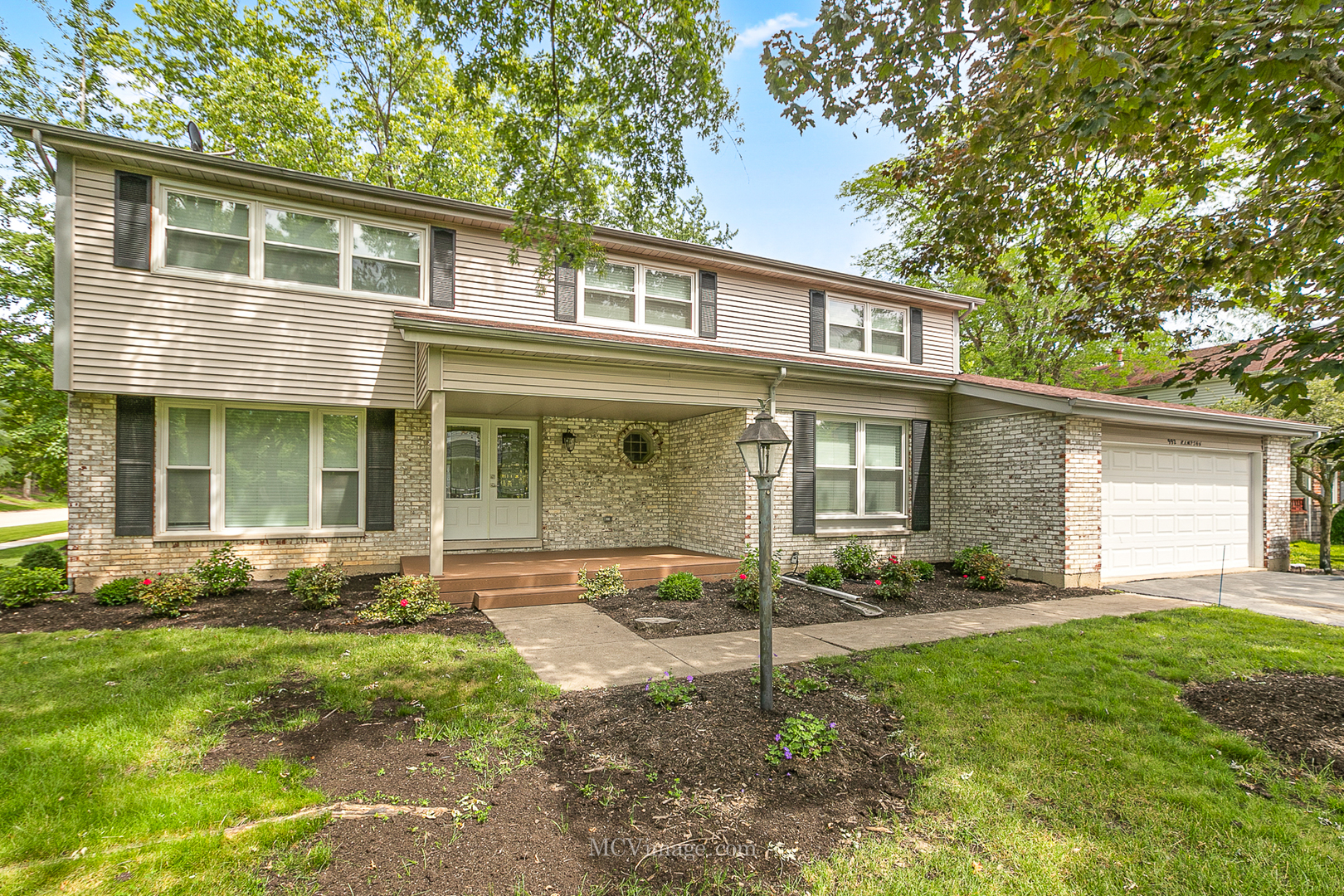 a front view of a house with a yard and outdoor seating