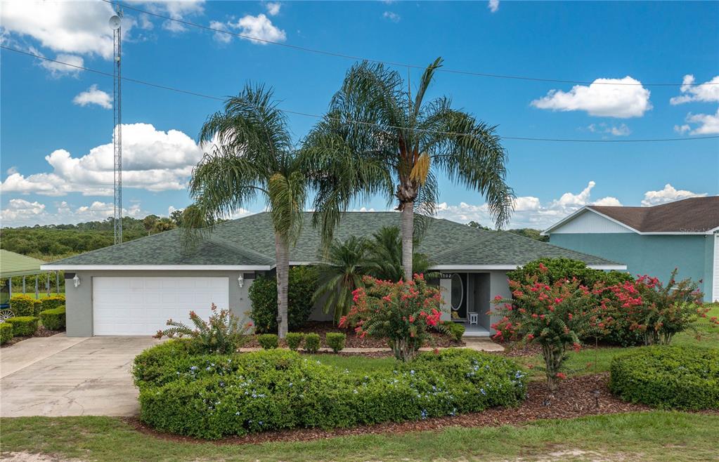 a front view of a house with a garden and a yard