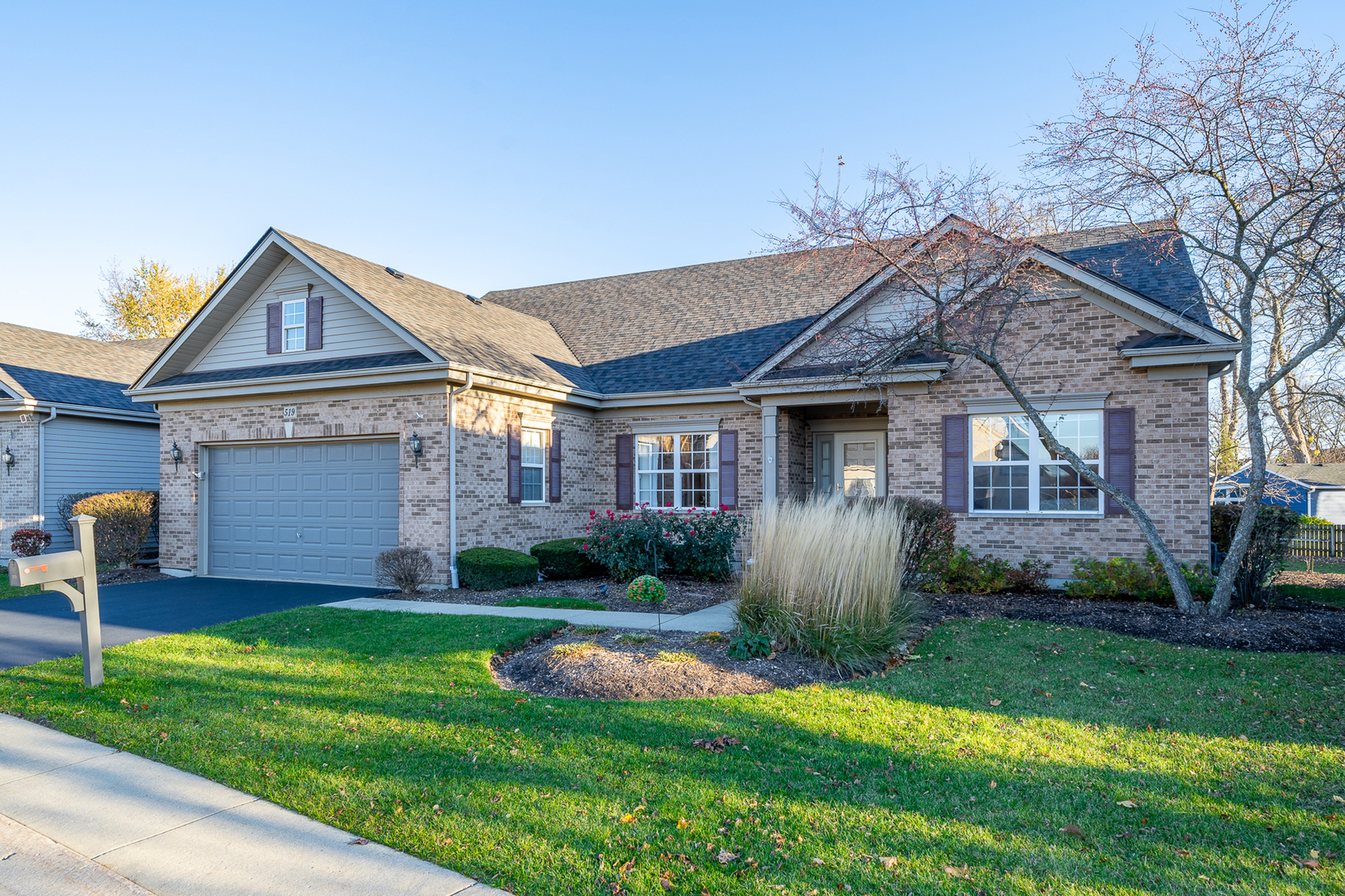 a front view of a house with a yard and garage