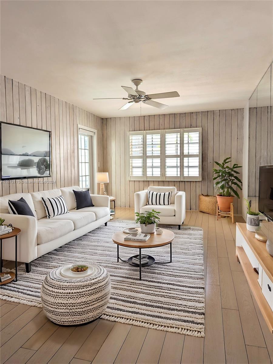 a living room with furniture a rug and a chandelier