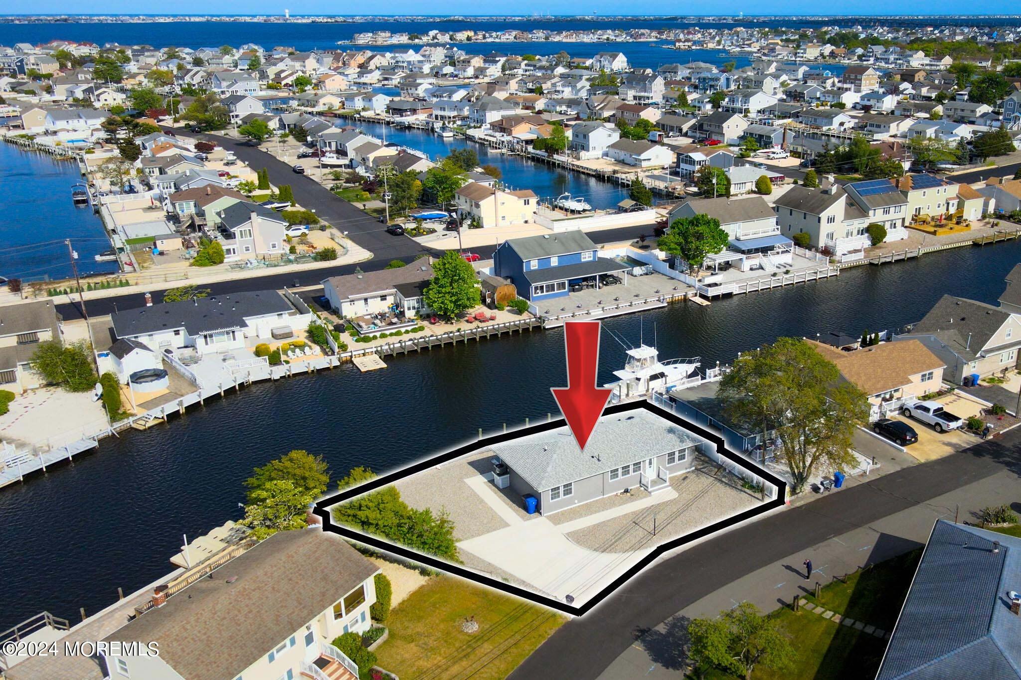 an aerial view of a house with a ocean view