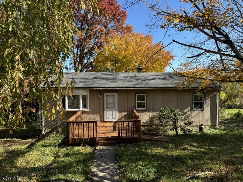 a front view of a house with a garden and plants