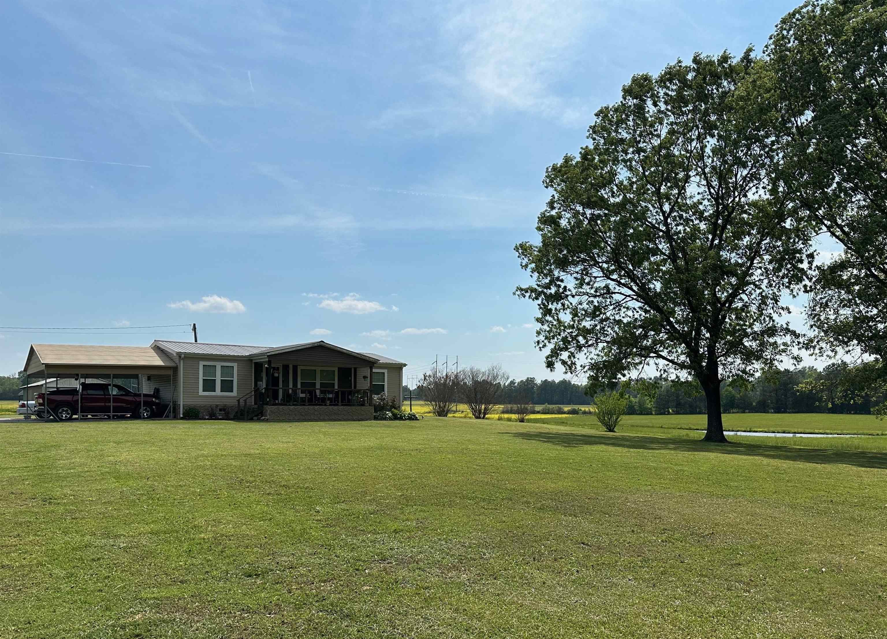 View of yard with a carport