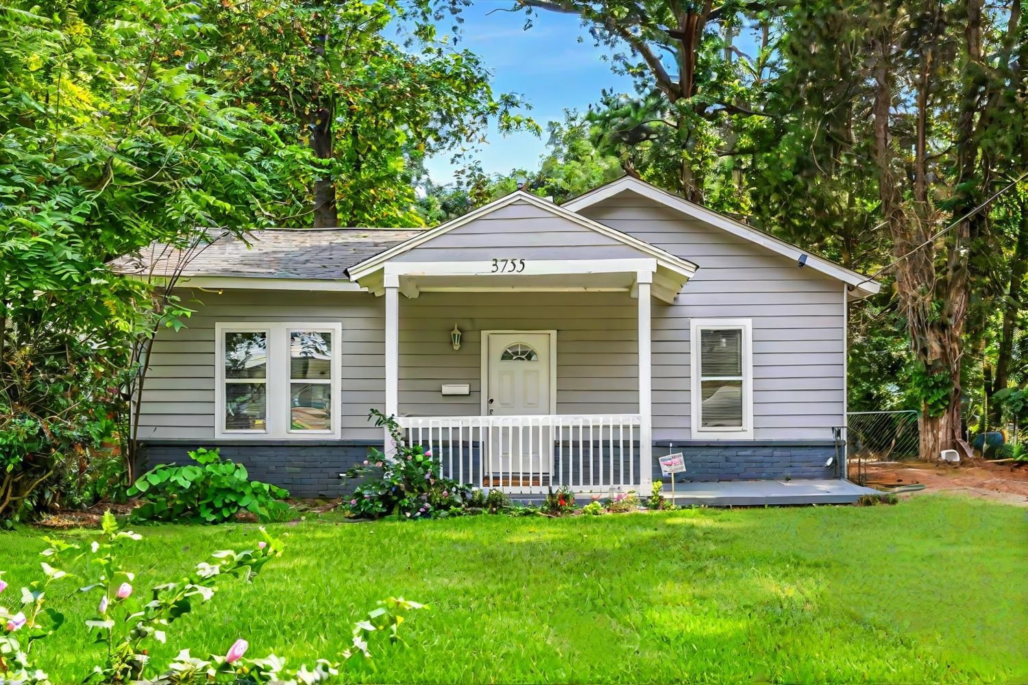 a front view of a house with a garden