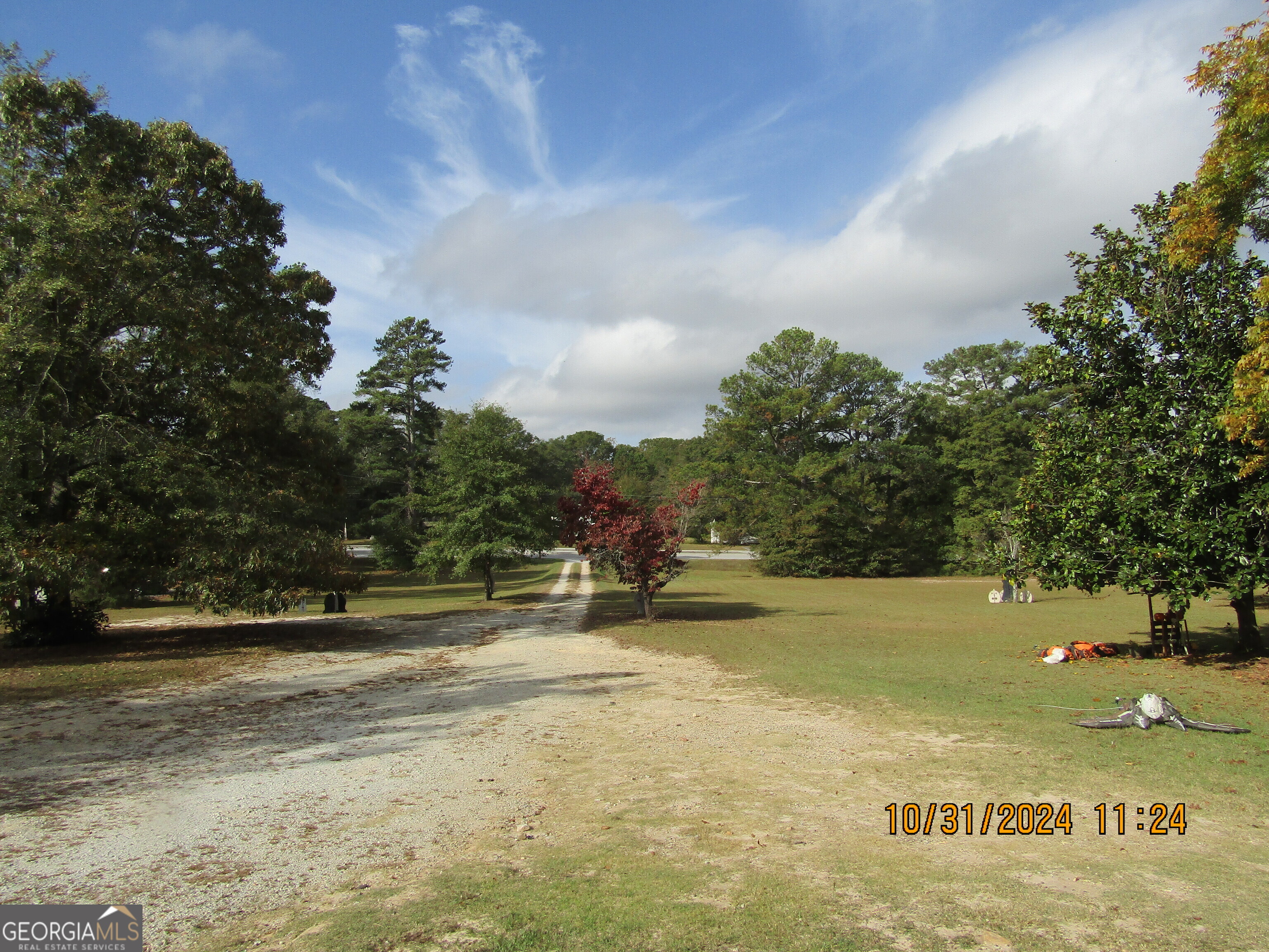 a view of swimming pool with outdoor seating and trees in the background