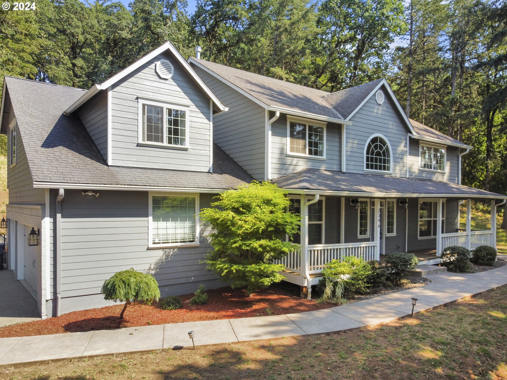 a front view of a house with garden