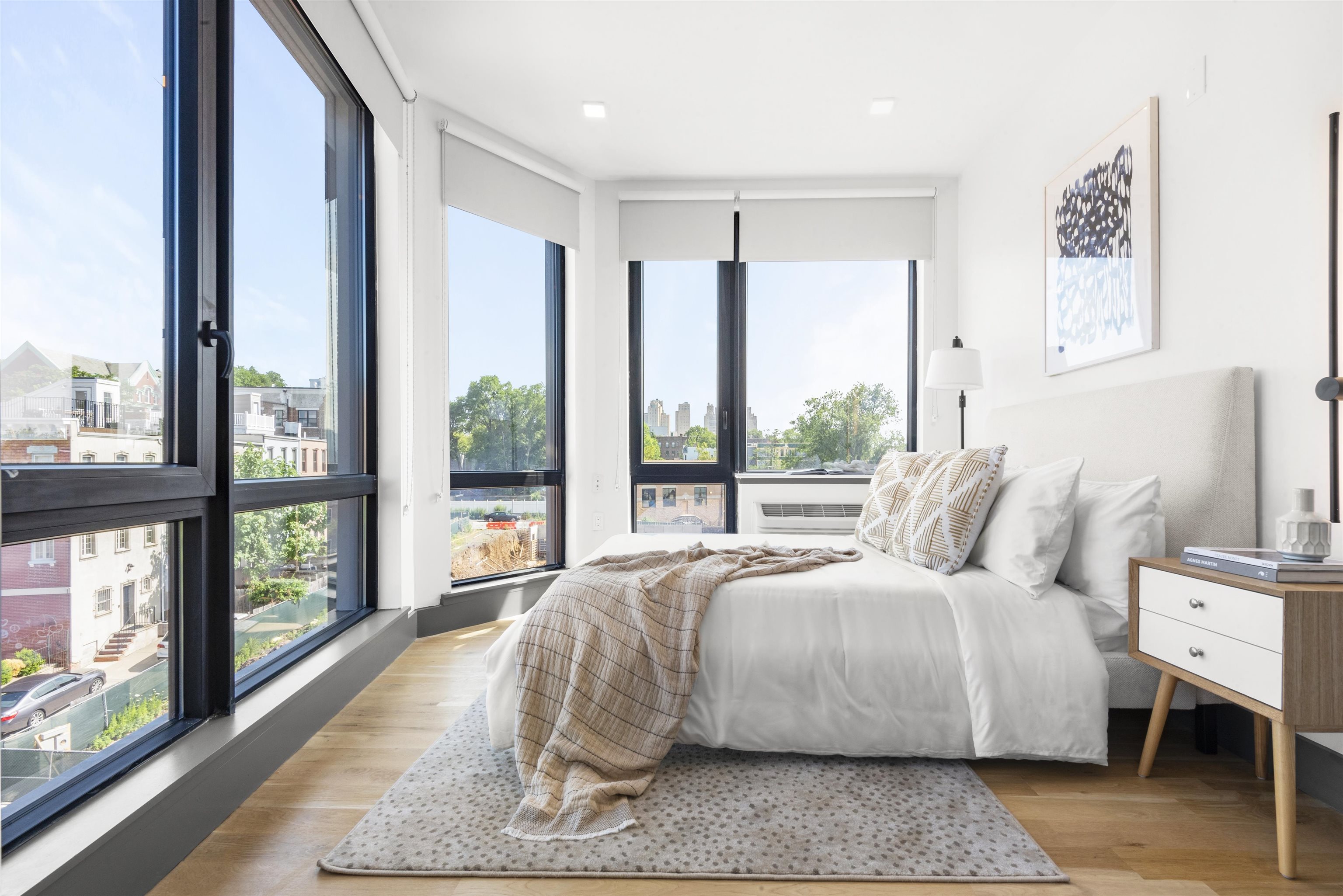 a bed room with a bed and a large window