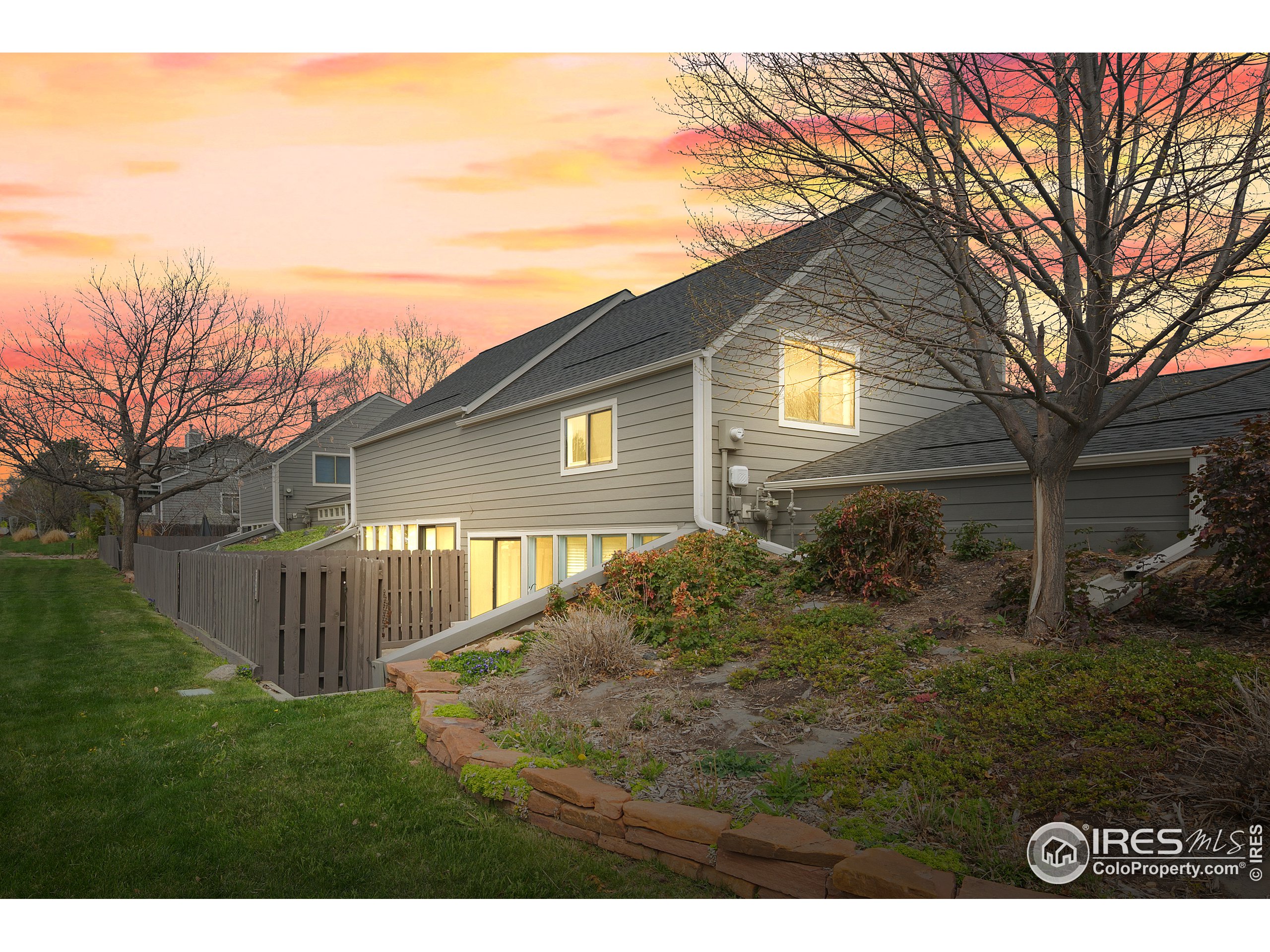 a backyard of a house with garden and outdoor seating