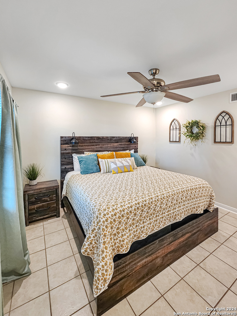 a bedroom with a bed and ceiling fan