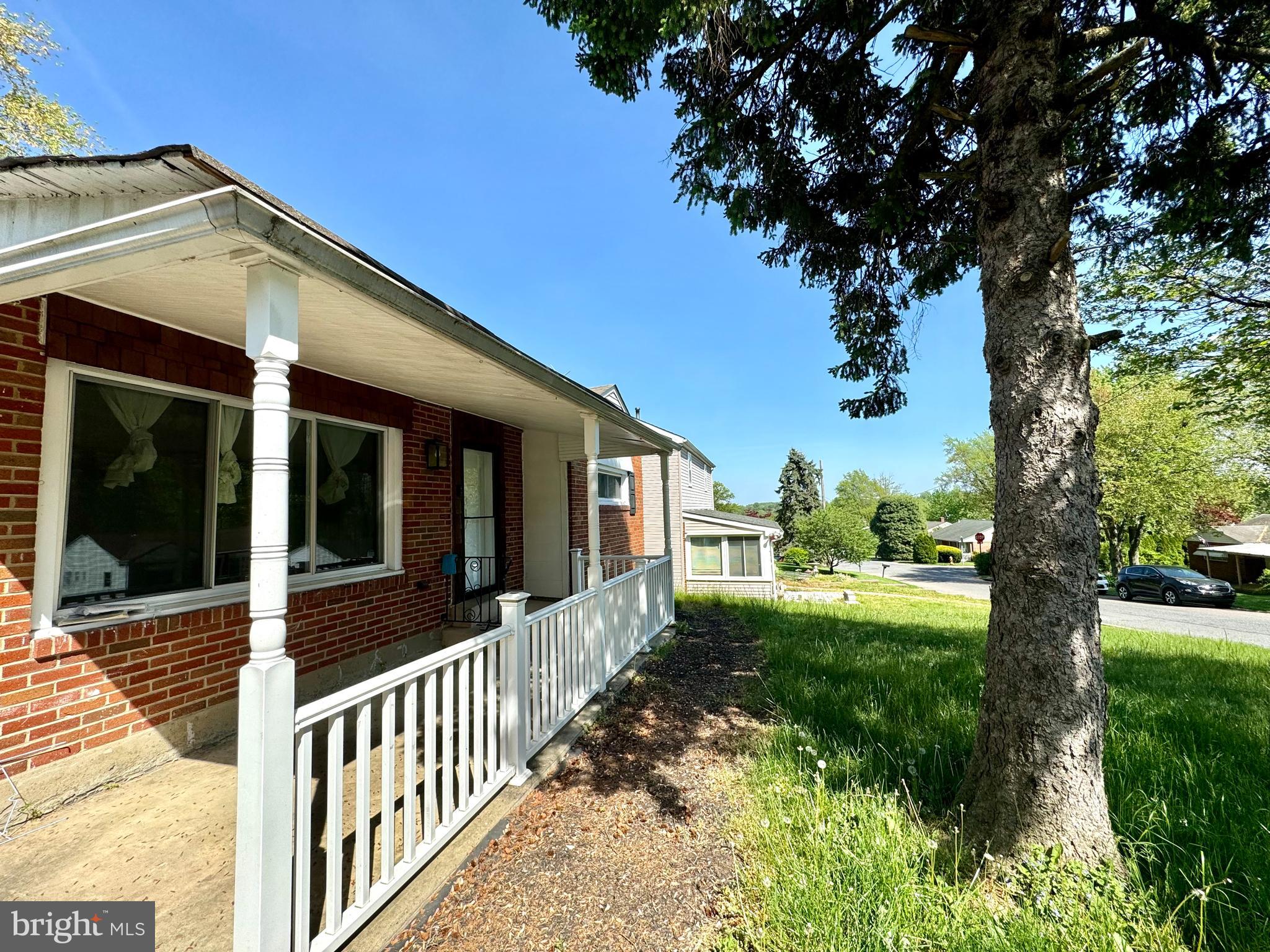 a view of a house with a tree in a yard