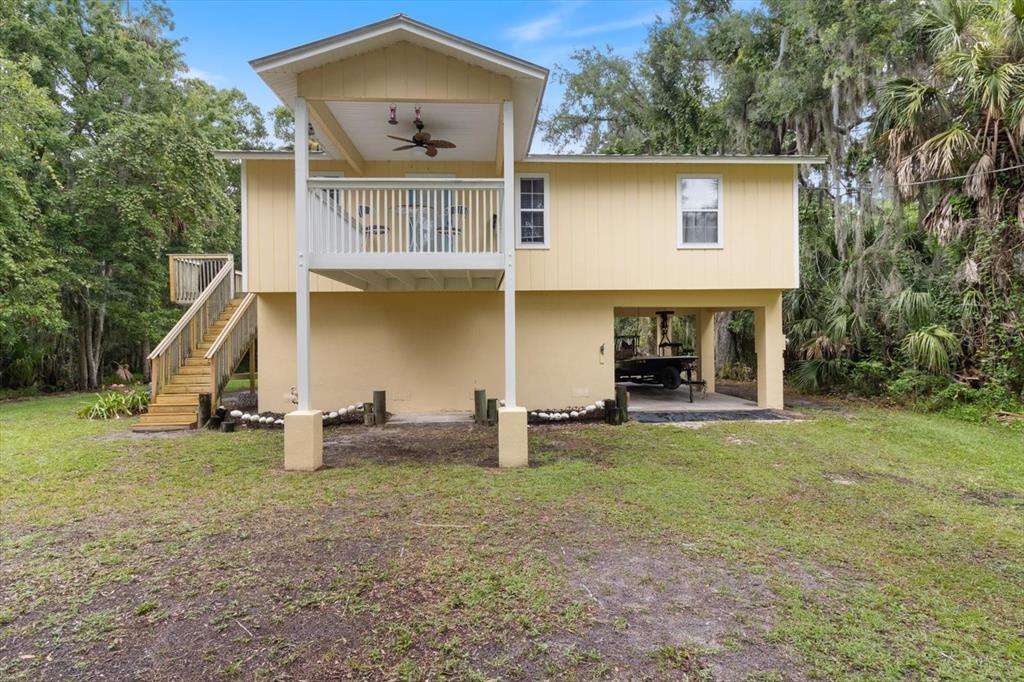 a view of a house with backyard and porch